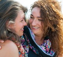 Lesbian couple hugging preparing for their first appointment