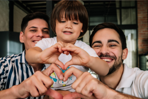 Two dads with a baby. Starting Your Journey with Rainbow Fertility.