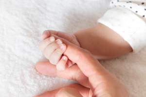 Medicare rebate. Baby holding their mums hand.