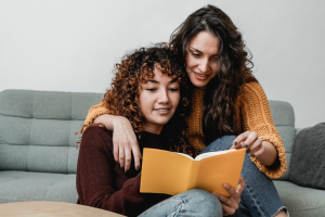 lgbt hispanic lesbian couple reading a book get started